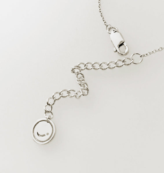 Joulala brand tag on baby komodo dragon silver necklace.