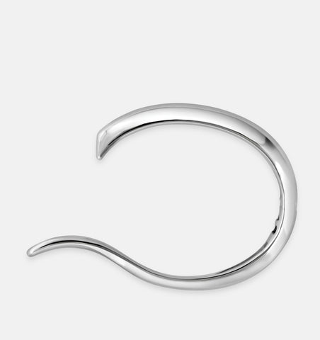 Statement hinged silver bangle with minimalist sculptural aesthetics.